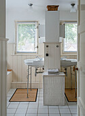 Bathroom with white sink and laundry basket