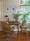 Study with desk, plants and leather chair