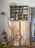 Country-style cupboard with wooden wall shelf and vintage decorations