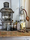 Antique glass bottles and oil lamp