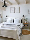 White bedroom with double bed and boho-style bedspread