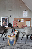 Workplace with pin board and rolls of wrapping paper in a basket