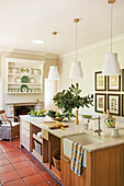 Bright country kitchen with cooking island, crockery collection and terracotta tiles