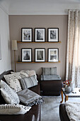 Cozy living room corner with black and white throw pillows and photo wall