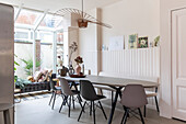 Dining room with modern table, dark chairs and sculptural lamp