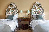 Bedroom with two single beds and floral headboards