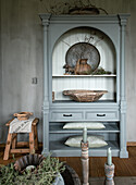 Light grey vintage cupboard with decorations