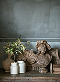 Antique bust and ceramic vases on a rustic wooden table