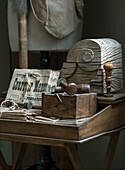 Antique desk with stamps, newspapers and decorative wooden block