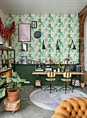 Home office with various plants, tropical wallpaper and round carpet