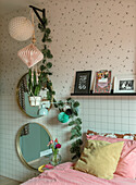 Teenage bedroom with floral decorations and round wall mirrors