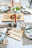 Festive table setting with wooden board, pretzels and candles