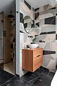 Modern bathroom with modern, geometric tiles and wooden washbasin