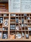 Font box with various letters and accessories on a desk