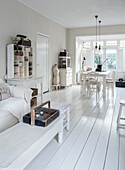 Bright Scandinavian-style living room with white wooden floors and furniture