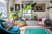 Spacious, bright living area with lots of houseplants and green carpet