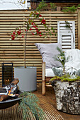 Patio with wooden privacy screen, bamboo chair, fire bowl, potted plant and decoration