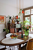 Dining room with vintage wooden furniture and hanging glass lamps