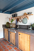 Low country kitchen with wooden base cabinets and blue painted ceiling