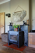 Wood-burning stove in cozy living room with decoration and fur wall hanging