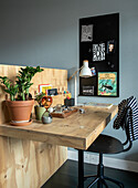 Pine wood desk with plants and pinboard in the modern study