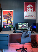 Modern desk with computer, lighting and Star Wars posters