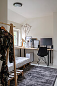 Work area in minimalist bedroom with wooden pallet bed