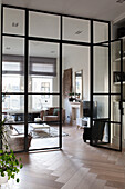 Living room with glass wall, modern furniture and light-coloured wooden floor