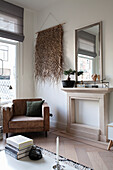 Brown armchair with woven wall hanging in the living room