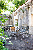 Seating area with metal chairs and table in an inner courtyard