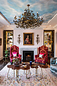 Baroque red velvet armchairs and trompe-l'œil canopy in a London drawing room
