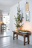 Scandinavian-style hallway with wooden bench and Advent arrangement