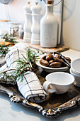 Silver tray with napkins and crockery on a worktop in the kitchen