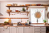 Bright country kitchen with open shelving and wooden accents