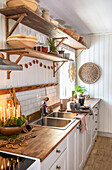 White country kitchen with open shelving and wooden accents