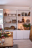 Shelves with rustic decorations and candles in the dining room