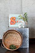 Decorative arrangement with illuminated letter "S", eucalyptus in vase and wickerwork