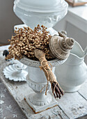 Decorative white stone vase with dried flowers