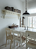 Dining area in shabby chic style with white wooden furniture and vintage lamps