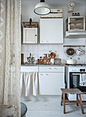 Vintage-style kitchen with white cabinets and wooden details