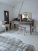 Vintage dressing table with wooden chair and stool in white bedroom