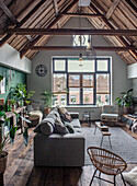 Loft-style living room with exposed beams and large windows