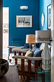 Sitting area with wooden furniture and blue walls in the living room