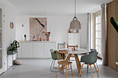 Bright dining area with round table top and chairs in pastel colours