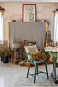 Rustic room with green chair and flax