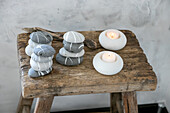 Painted stones and tealight candles on a rustic wooden stool