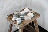 Maritime decoration made of painted stones and fish silhouettes on a rustic wooden stool