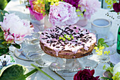 Table setting with chocolate cake and bouquet of peony flowers