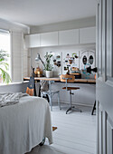 Work area in the bedroom with desk, chairs and decorations