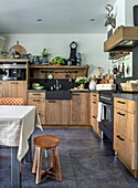 Rustic kitchen with wooden elements, dark worktop and vintage decorations